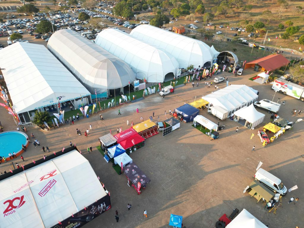 Aerial photo capturing an outdoor event with multiple tents in Maputo, Mozambique.